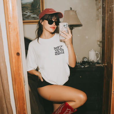 DON’T TELL ME TO SMILE GRAPHIC TEE