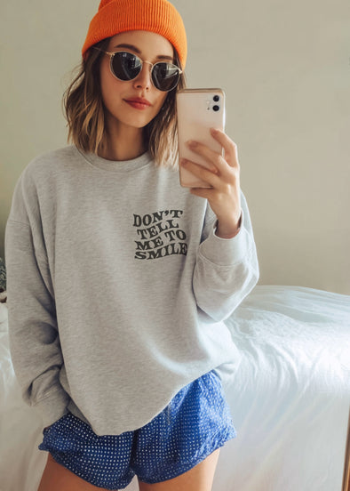 DON’T TELL ME TO SMILE CREWNECK